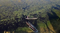 an aerial view of two boats floating in a body of water
